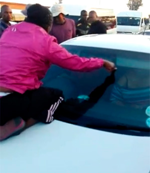 Mulher flagra marido no carro com outra e sobe no para-brisa para impedir que ele fuja